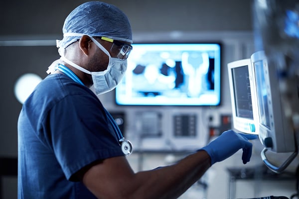 A surgeon checking a monitor in the operating room