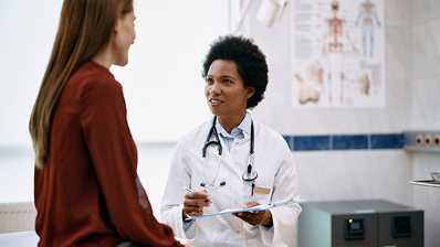 Patient talking with doctor in exam room