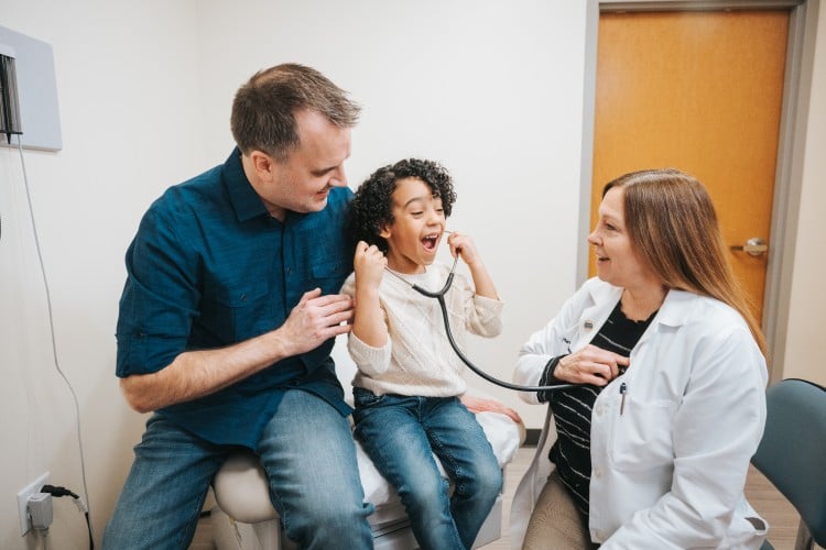 Family getting a checkup in an exam room