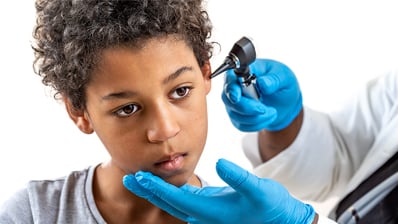 Boy getting ear checked by ENT