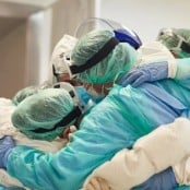 Providers in scrubs in a huddle