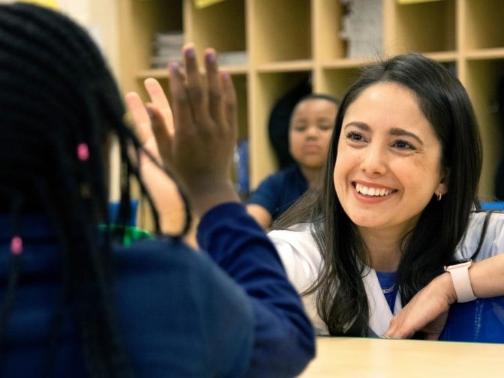 Doctor Lisa Ramirez giving a child a high five
