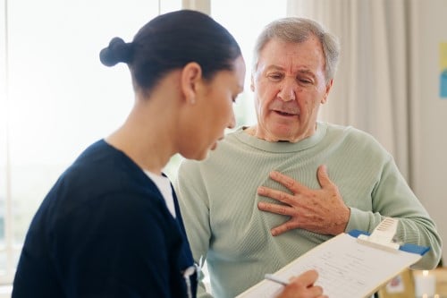 Patient explaining chest pain to doctor