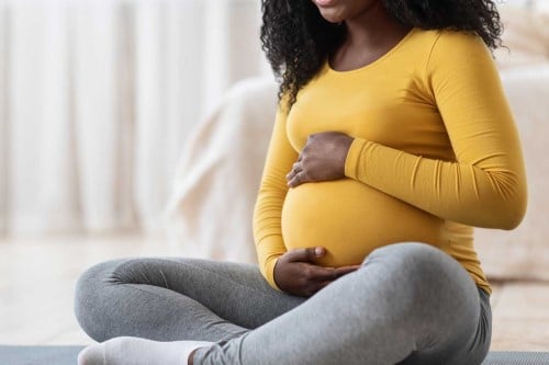 Pregnant woman holding belly