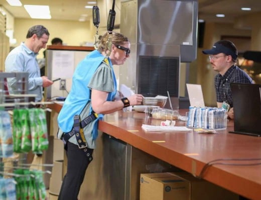 Dee Cottrell working independently at a cafeteria counter
