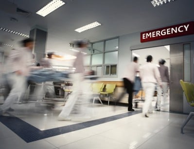 Care providers rushing a bed into the emergency room