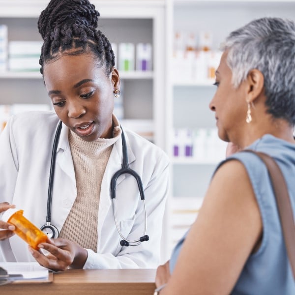 Pharmacist speaking to patient