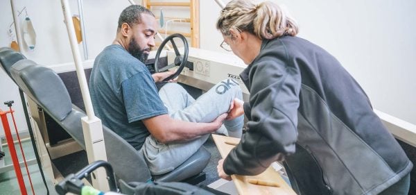 A Rehabilitation patient in a mockup driver's seat
