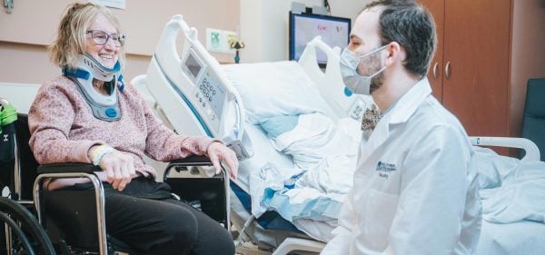 A smiling Rehabilitation patient with a neck brace