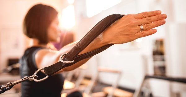 A patient using Pilates equipment