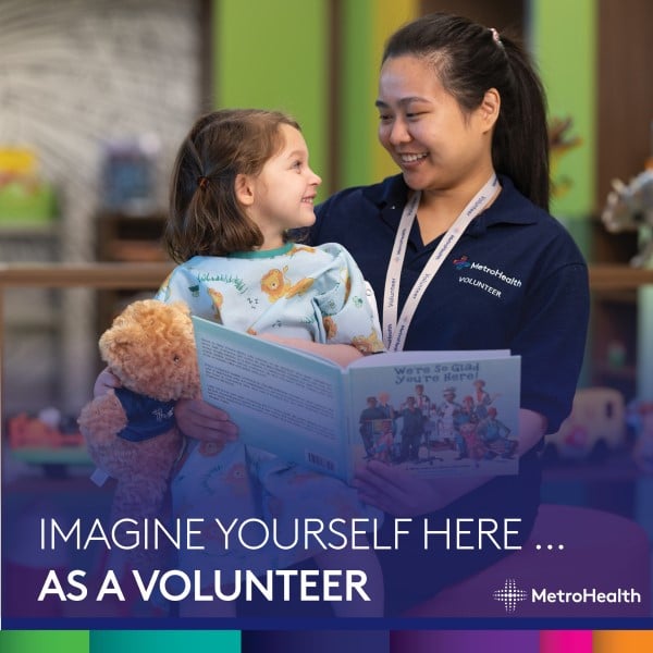 Volunteer reading to patient