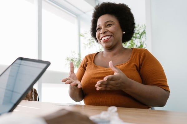 Woman smiling as she talks to doctor