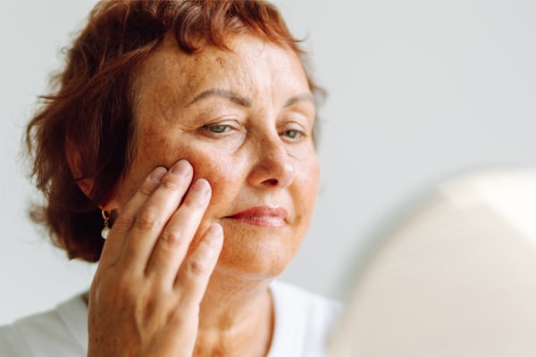 A woman checking her reflection in a mirror