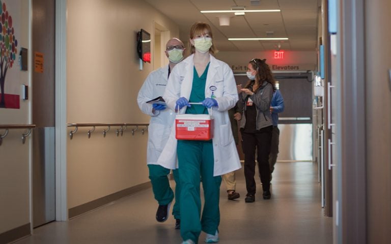 Doctor carrying a transplant container