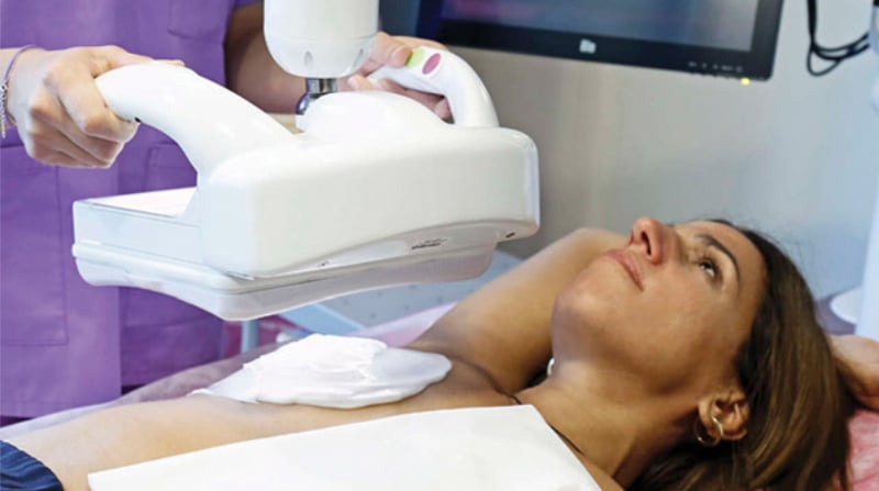 Automated breast ultrasound being performed