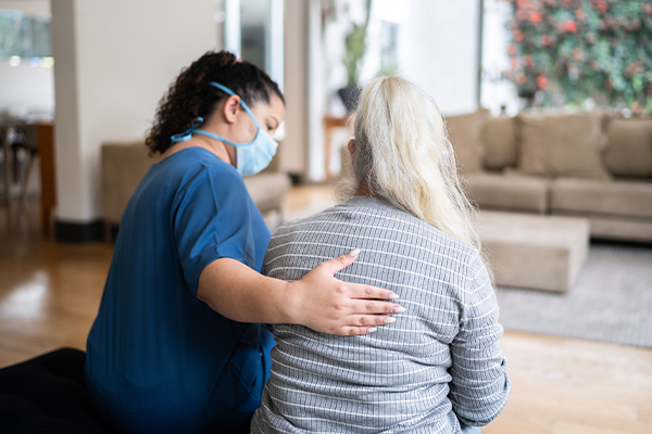 A social worker reassures a woman