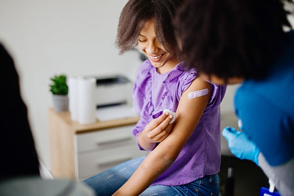 Patient with bandage after receiving vaccination