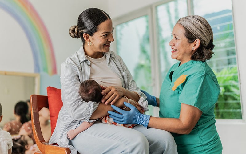 Nurse with mom and newborn
