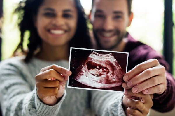 Couple holding ultrasound image