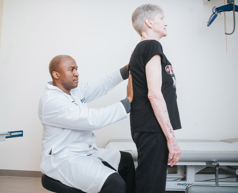 Provider testing patient's spine alignment