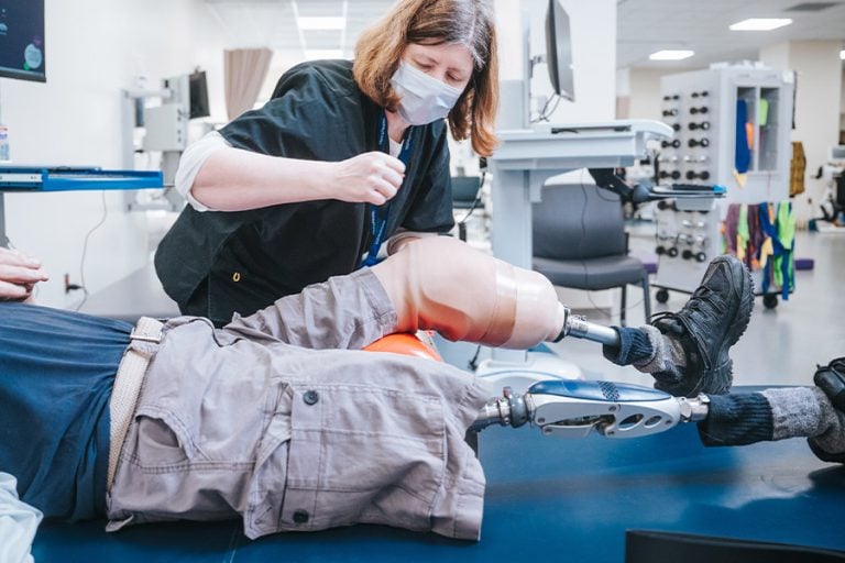 A Rehabilitation patient getting prosthetic legs checked