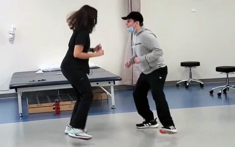 Rehabilitation patient and provider practicing an exercise