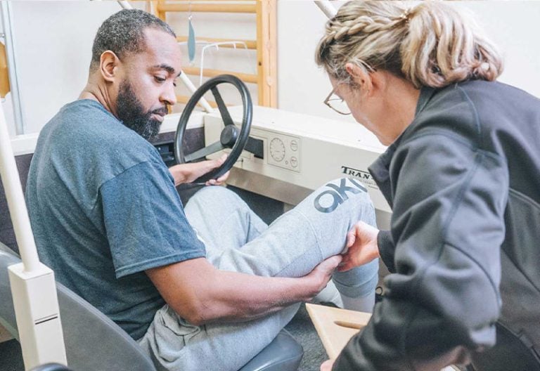 A patient in a model driver's seat