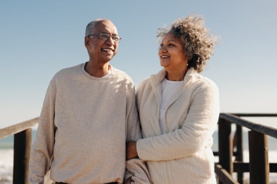 Couple holding hands on beach